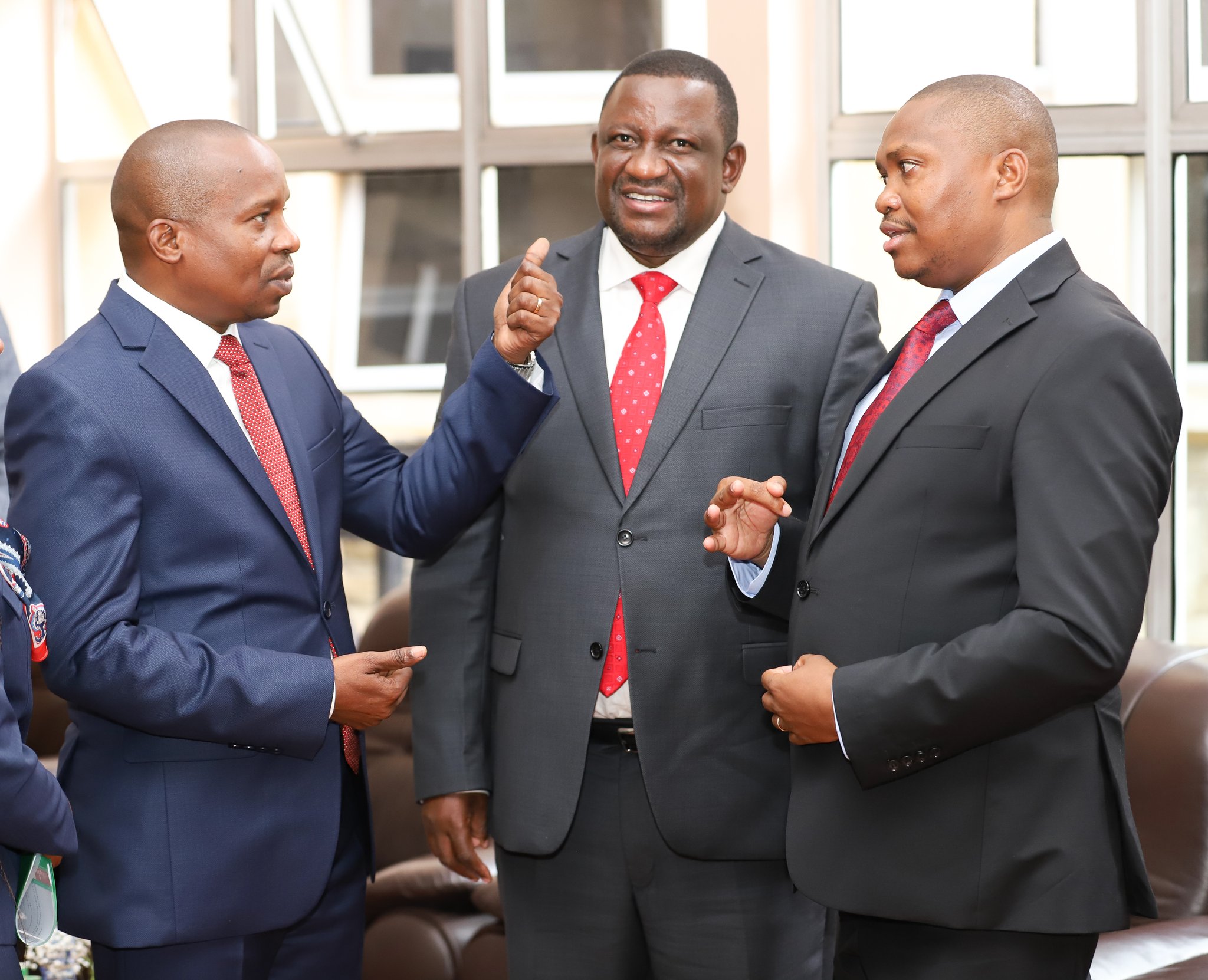 CS Interior Prof. Kithure Kindiki (L), CS Mining Salim Mvurya (C) and PS Mining Elijah Mwangi (R) chatting before responding to questions from senators. 