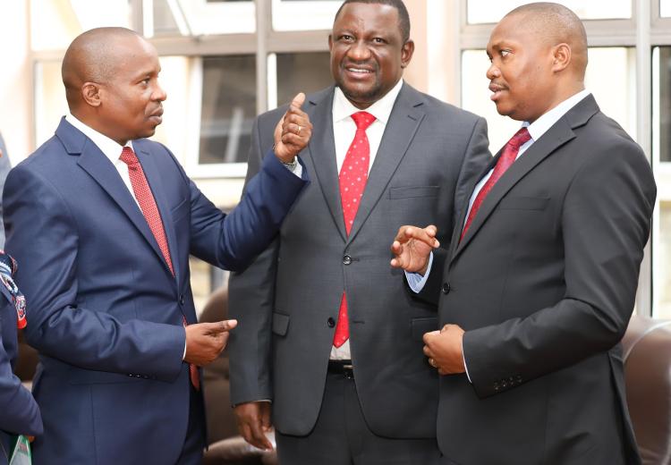 CS Interior Prof. Kithure Kindiki (L), CS Mining Salim Mvurya (C) and PS Mining Elijah Mwangi (R) chatting before responding to questions from senators. 